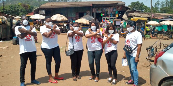 Distributing face masks during sensitization campaign  and awarding certificates at the end of workshop on mainstreaming gender in reporting COVID 19